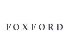 The image shows the word FOXFORD in uppercase, grey serif letters centred on a light grey background, subtly evoking the tranquil atmosphere often associated with Mayo Roscommon Hospice.